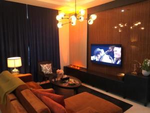 a living room with a couch and a tv at Dana Hotel & Residences 2 in Riyadh