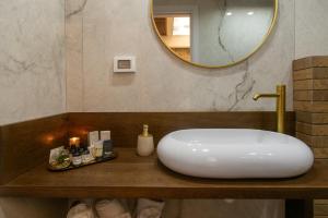 a bathroom with a white sink and a mirror at kadarim Boutique Suites-beachfront Zimmer in Haifa