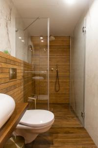 a bathroom with a toilet and a glass shower at kadarim Boutique Suites-beachfront Zimmer in Haifa