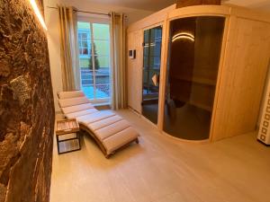 a living room with two chairs and a large window at Apart Hotel Haveltreff in Caputh