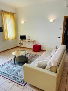 a living room with a couch and a table at Residenza Villa in Corno Alto