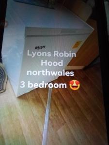 a pizza box sitting on top of a wooden floor at Deluxe 3 bedroom Lyons Robin hood oaklands with free wifi free sky in Meliden