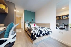 a bedroom with a bed and a desk and a chair at Private Bedrooms with Shared Kitchen, Studios and Apartments at Canvas Wembley in London in London