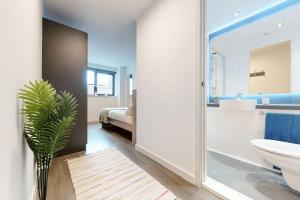 a bathroom with a toilet and a sink and a tub at Private Bedrooms with Shared Kitchen, Studios and Apartments at Canvas Wembley in London in London