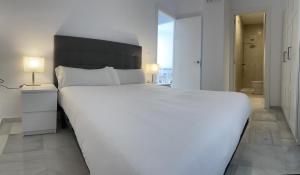 Posteľ alebo postele v izbe v ubytovaní Apartamentos Registro Ronda Centro + 9 fotografií