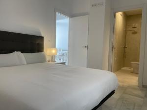 Posteľ alebo postele v izbe v ubytovaní Apartamentos Registro Ronda Centro