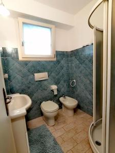 a bathroom with a sink and a toilet and a shower at Il Nido Di Tonfano in Marina di Pietrasanta