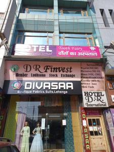 a store front of a building with signs on it at Hotel D R International in Ambāla