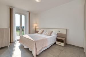 Łóżko lub łóżka w pokoju w obiekcie Appartamenti Villa Campo Rosso