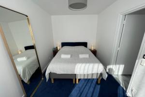 a bedroom with a bed and a mirror at GuestReady - Superb Apt near Antique District in Saint-Ouen