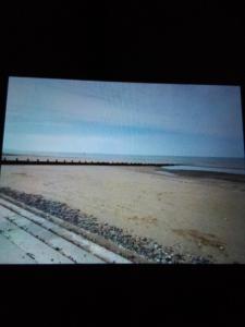 a view of a beach with the ocean in the background at Deluxe 3 bedroom Lyons Robin hood oaklands with free wifi free sky in Meliden