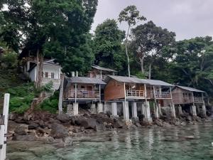 a group of houses on a rocky river at Olala Bungalows And Restaurant Mitra RedDoorz in Banda Aceh