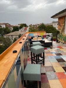 a balcony with a colorful tile floor and chairs at Hakuna Matata Guest House in Plovdiv