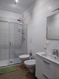 a bathroom with a toilet and a sink and a shower at GDB HOUSE in Molfetta