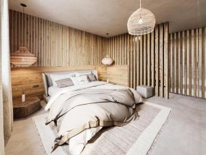バルダーシュヴァングにある4Monkeys Apartmentsの大きなベッドと木製の壁が備わるベッドルーム1室が備わります。