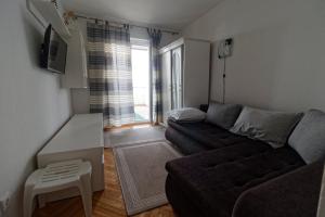 uma sala de estar com um sofá e uma mesa em App2 Marin em Šilo
