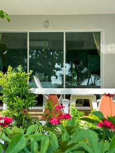 a table and chairs and flowers in front of a building at Lanta A&J Klong khong Beach in Ko Lanta