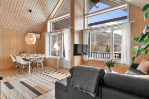 a living room with a couch and a table at Mikkelparken Ferietun in Kinsarvik