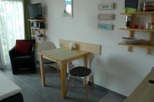 a small table and a chair in a room at Appartment 530 in Tossens in Tossenserdeich