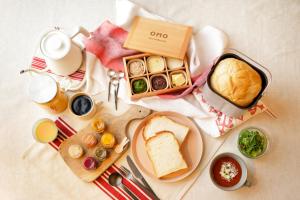 a table with a breakfast of bread and a cup of coffee at OMO5 Kyoto Gion by Hoshino Resorts in Kyoto