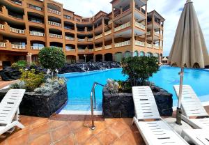 a hotel with a swimming pool in front of a building at Best4U Nautico in San Miguel de Abona