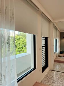a room with a large window with white blinds at HoME-Easyhouse-III in Tainan