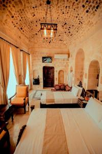 a large bedroom with two beds and a chair at CARRA KONAĞI in Mardin