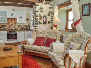 a living room with a couch and a table at Swallow Barn in Haverfordwest