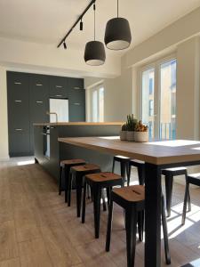 a kitchen with a large wooden table and chairs at Appart'Alencon in Alençon