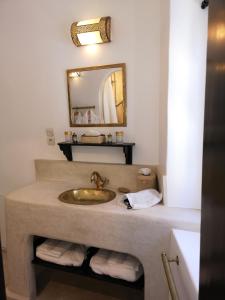 a bathroom with a sink and a mirror at Riad de charme l'Oasis d'Essaouira - Suite Luxe in Essaouira