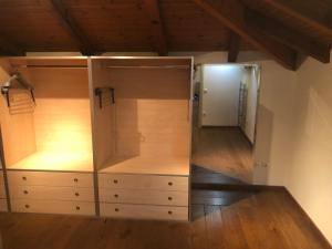 a dressing room with wooden cabinets and a mirror at Zack's Piccolo Comfort in Athens