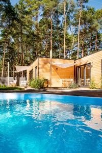 una casa con piscina frente a una casa en Seaside Harmony en Pogorzelica