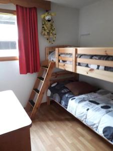 a bedroom with two bunk beds and a bed at T3 puy st Vincent 1800 in Puy-Saint-Vincent