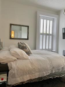 a bedroom with a bed with a mirror on the wall at Ugthorpe Lodge Hotel in Whitby