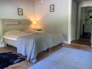 a bedroom with a bed and a blue rug at Brunsbergs Herrgård appartement in Brunskog