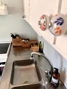 a kitchen counter with a sink in a kitchen at Brunsbergs Herrgård appartement in Brunskog