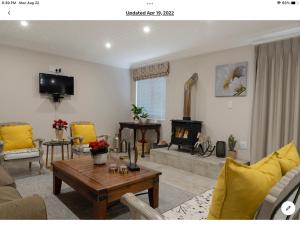 a living room with a couch and a fireplace at Rueby’s Apartment 101 in Dullstroom