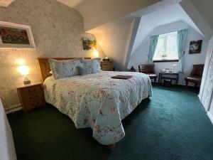 a bedroom with a large bed and a window at The Courthouse in Betws-y-coed