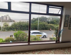 a window with a view of a car in a parking lot at Savoy Hotel in Weston-super-Mare