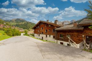 an empty road in front of a brick building at Le Beauregard in Le Grand-Bornand