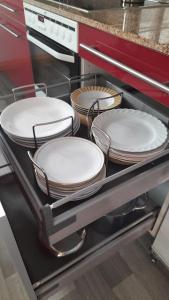 four plates are sitting on a shelf in a kitchen at Paulus Gästehaus Top 2 in Salzburg