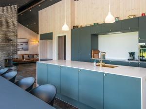- une cuisine avec des placards bleus et un évier dans l'établissement 12 person holiday home in Haderslev, à Haderslev