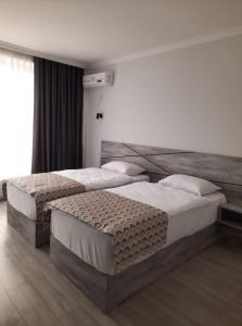 Voodi või voodid majutusasutuse Aventus Hotel toas