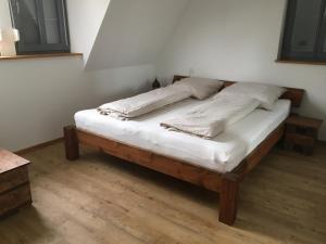 a bed with two pillows on it in a room at Häuschen in der Altstadt Dettelbach in Dettelbach