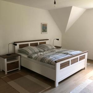 a bedroom with a large bed with a night stand at Ferienwohnung am Eggegebirge in Bad Driburg