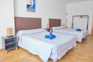 a room with three beds with stuffed animals on them at Alojamiento Particular in Almería