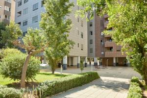 a courtyard in a building with trees and bushes at Alojamiento Particular in Almería