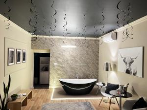 a bathroom with a bath tub in a room at Margaréta Garden & SPA in Eger