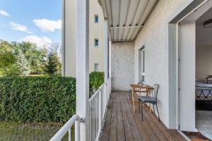 a porch with a table and a chair at Bright 3-room apartment near Prenzlauer Berg in Berlin