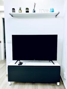 a large flat screen tv sitting in a living room at Apartament Bonaire in L'Escala